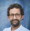 a man with a beard and glasses posing for a picture
